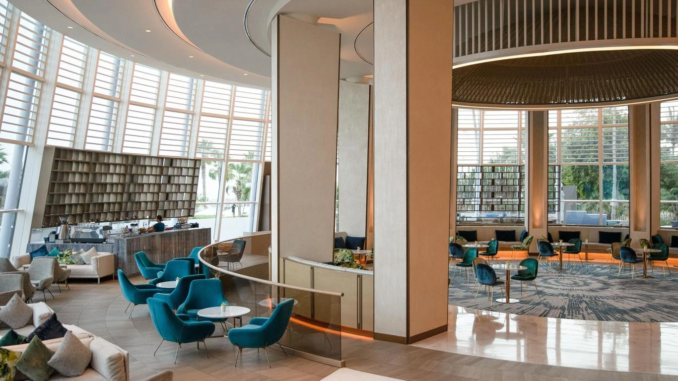 Modern lounge area at Jumeirah Beach Hotel, Dubai with blue chairs.