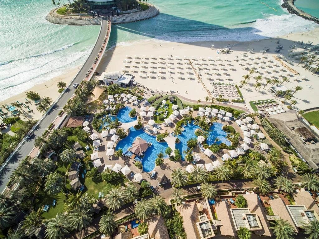 Aerial view of Jumeirah Beach Hotel, Dubai, with pools and beach.