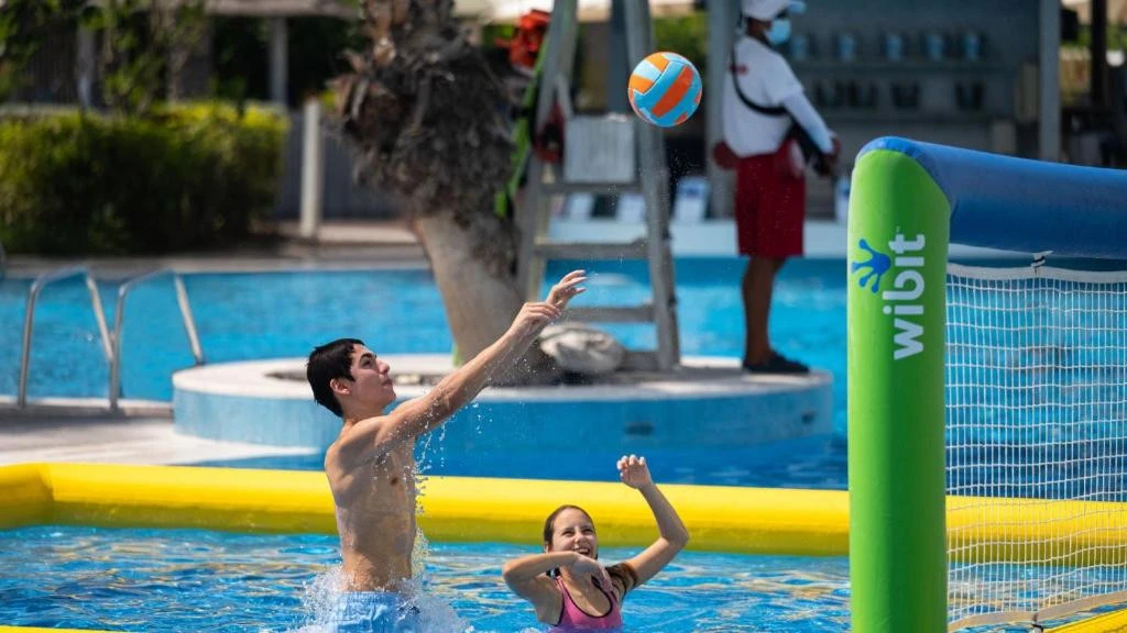 People playing water volleyball at Jumeirah Beach Hotel, Dubai pool.