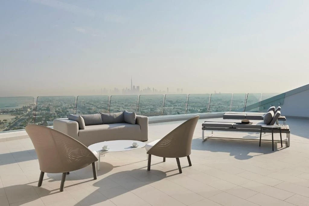 Jumeirah Beach Hotel rooftop terrace with Dubai skyline view.