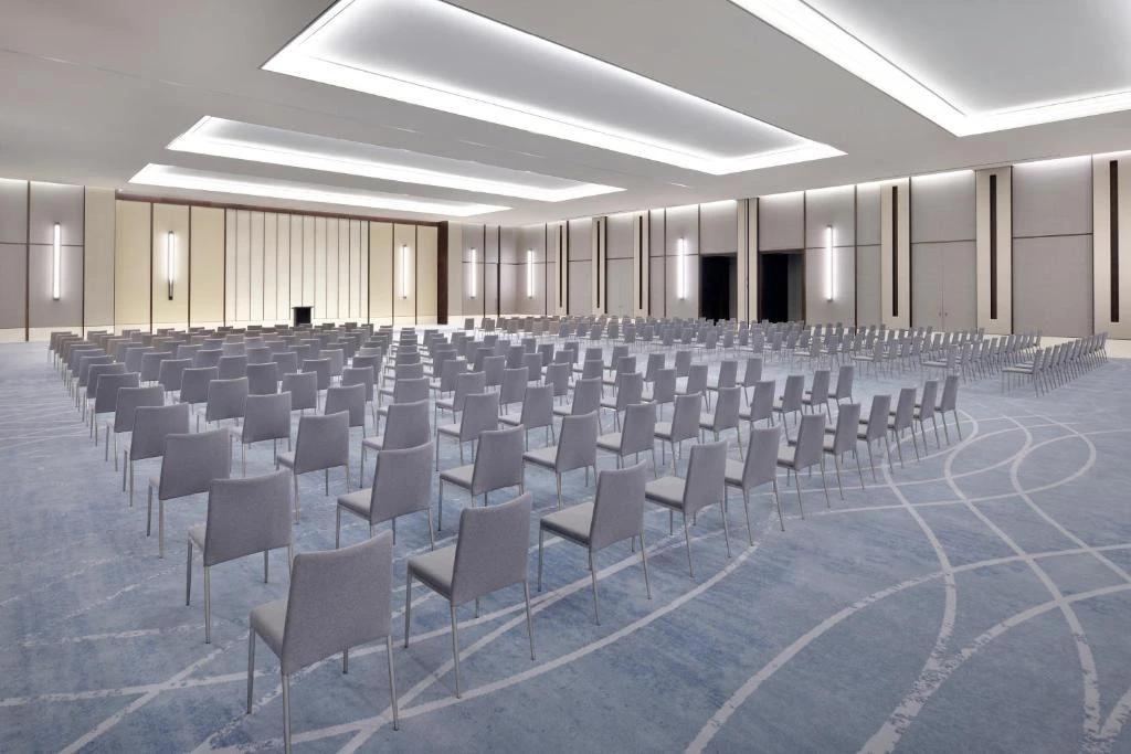 Expansive hall with aligned seating at Address Sky View, Dubai.