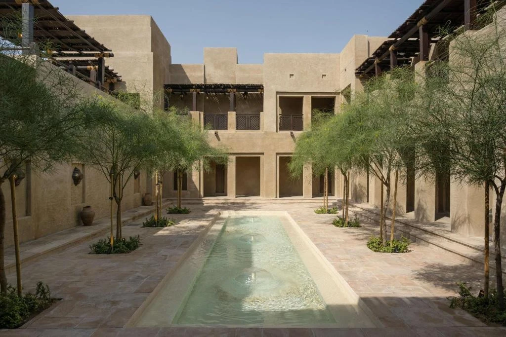 Bab Al Shams courtyard with pool and trees, Dubai resort.