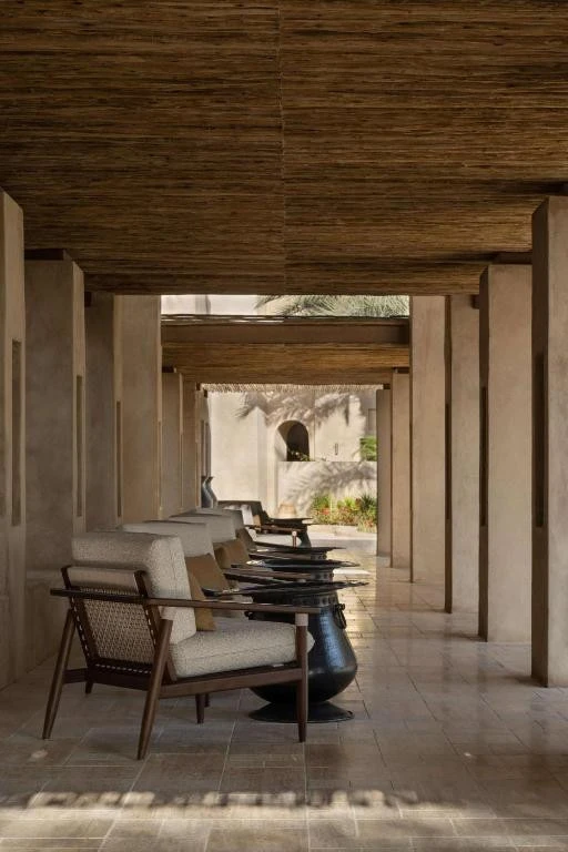 Bab Al Shams resort corridor with chairs, Dubai desert ambiance.