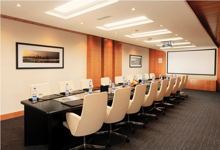 Dubai World Trade Centre meeting room with projector and framed artwork.