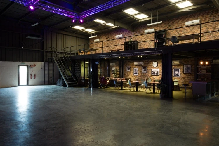 Spacious industrial venue, Warehouse Four, Dubai with brick walls and seating.