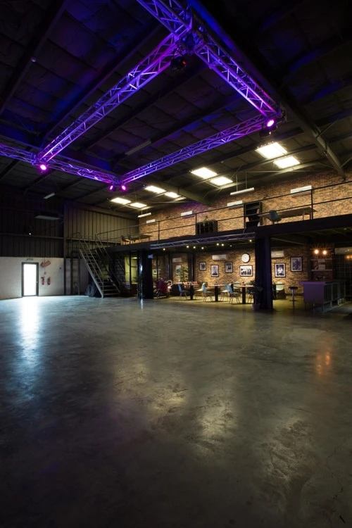 Spacious interior of Warehouse Four, Dubai, with industrial decor and lighting.