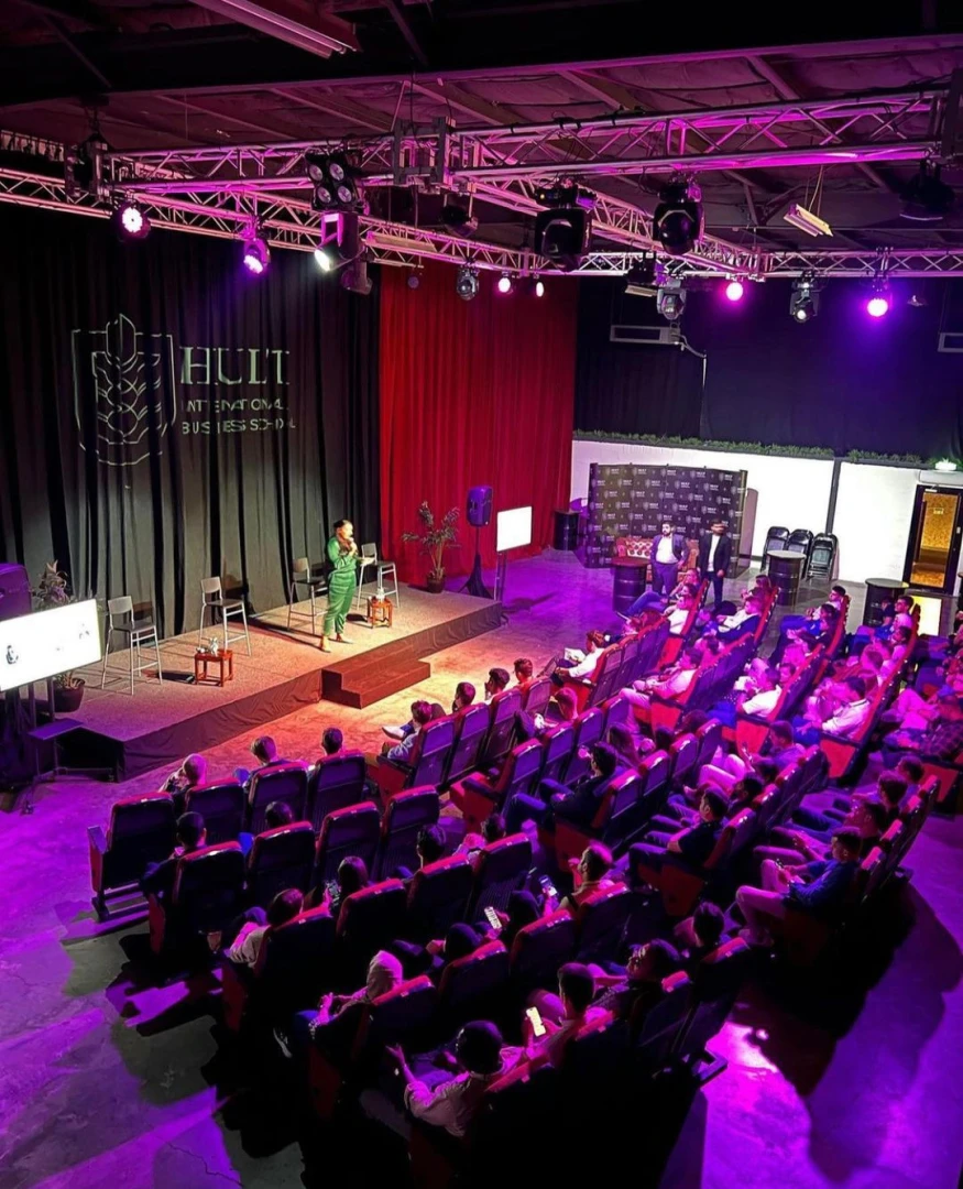 Audience seated at Warehouse Four event venue in Dubai.