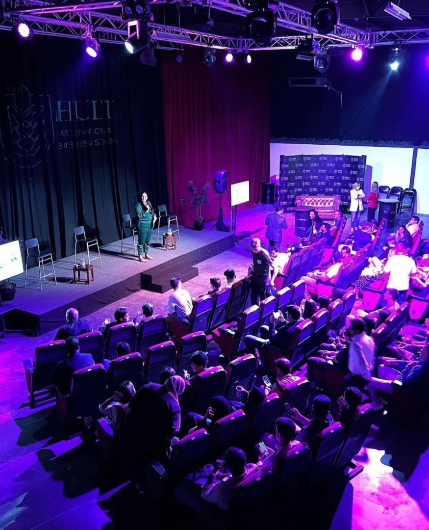 Warehouse Four Dubai event with audience and speaker on stage.