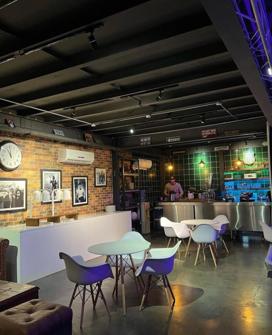 Warehouse Four Dubai, modern interior with tables and bar area.