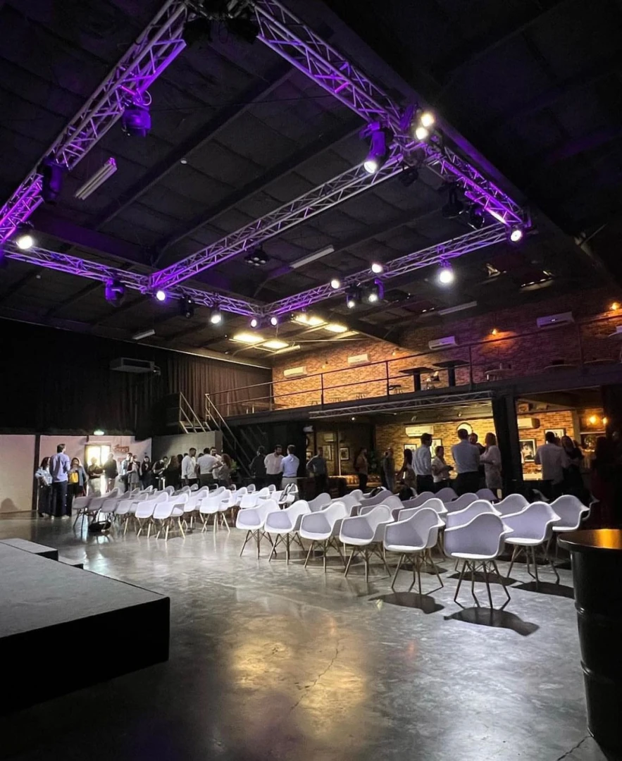 Warehouse Four Dubai event space with chairs and purple lighting.