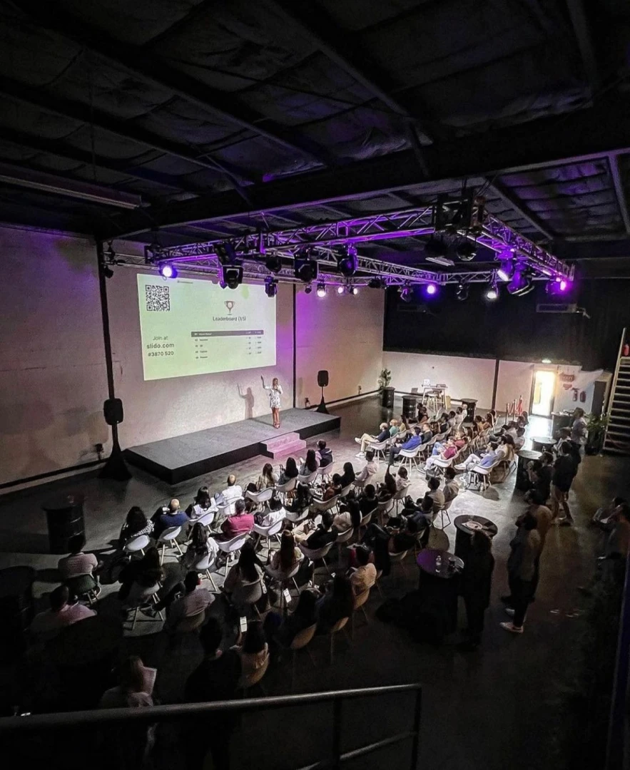 Audience seated in Warehouse Four, Dubai, during a presentation.