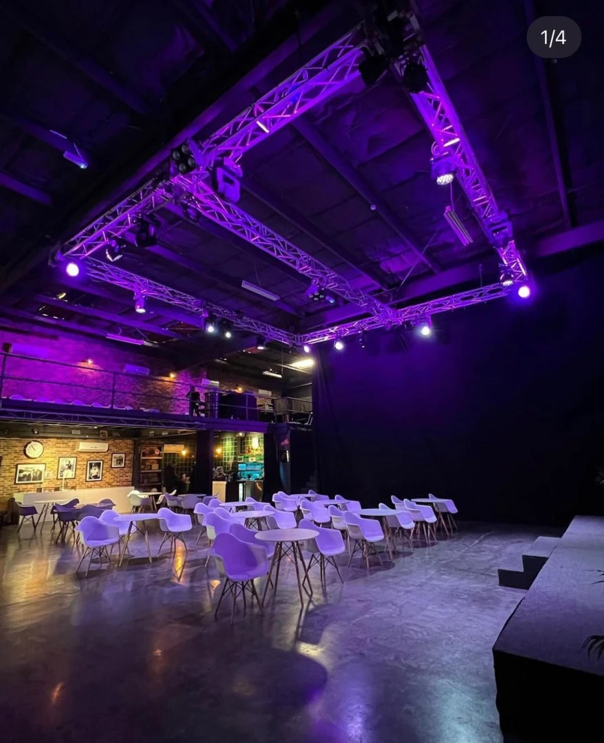 Warehouse Four Dubai venue with purple lighting and seating arrangement.