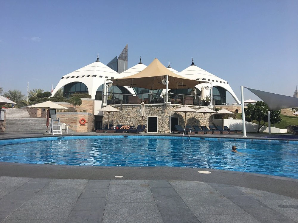 Emirates Golf Club poolside with modern architecture, Dubai.