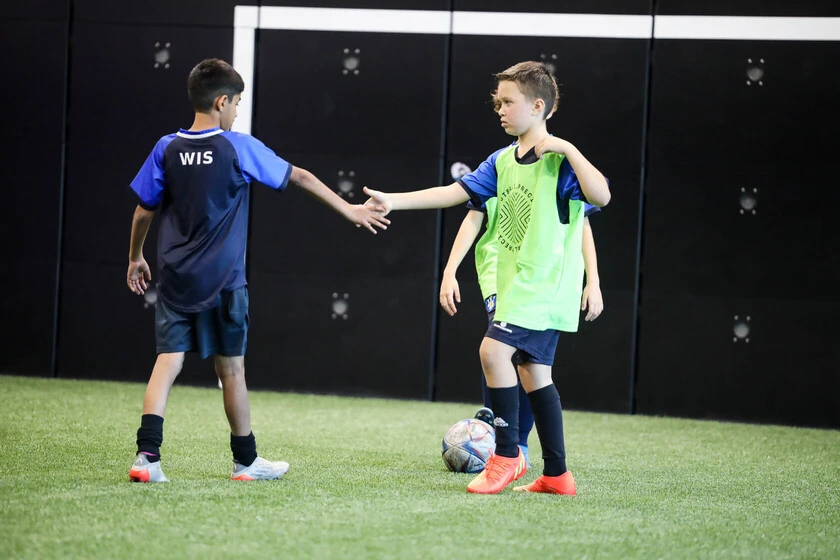 Children playing football at Precision Football venue in Dubai.
