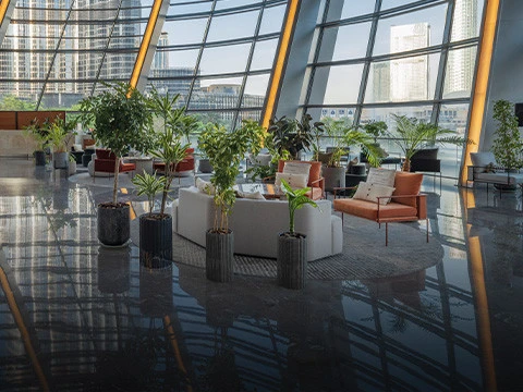 Modern lounge area inside Dubai Opera with city views.