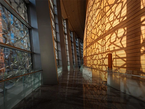Sunlit hallway inside Dubai Opera with geometric wall patterns.