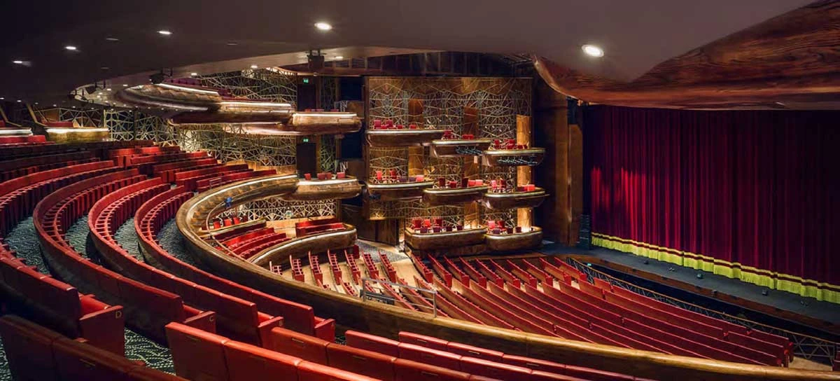 Interior of Dubai Opera with red seats and stage, Dubai.