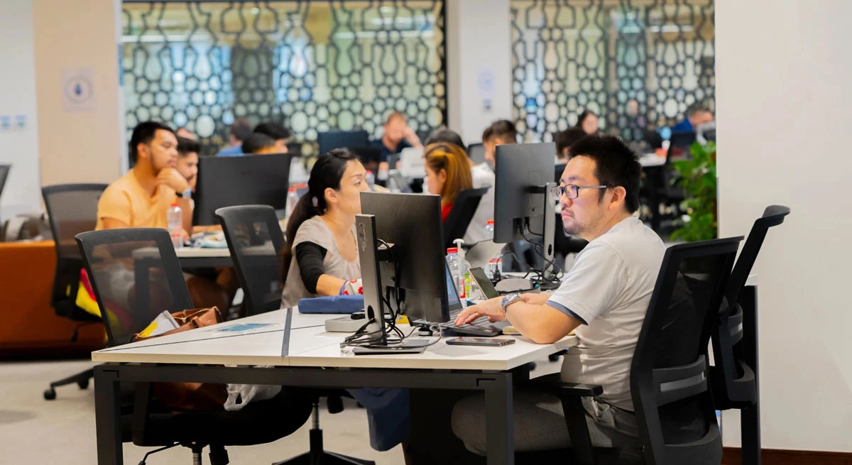 People working at AstroLabs Coworking Space in Dubai.