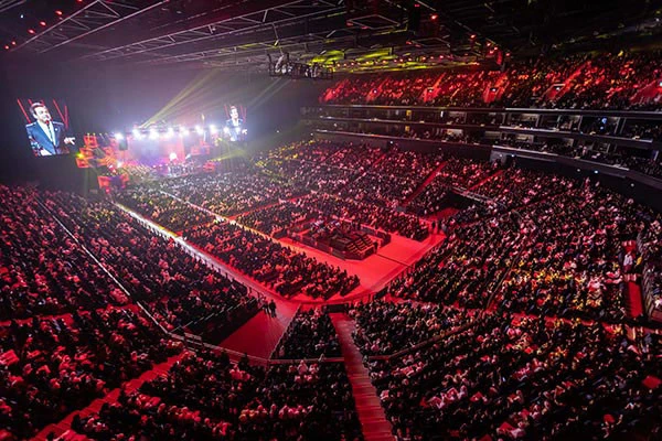 Crowded Coca-Cola Arena in Dubai during a vibrant evening event.