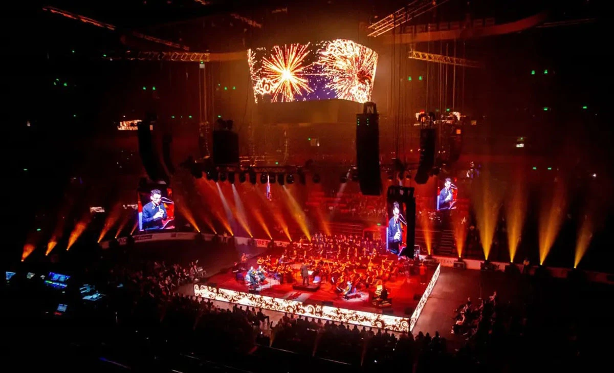 Concert with fireworks at Coca-Cola Arena, Dubai, vibrant lighting display.
