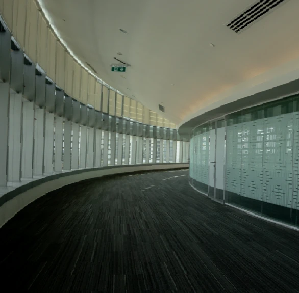 Curved hallway in Jafza One Convention Centre, Dubai with glass walls.
