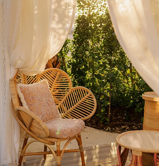 Cozy rattan seating area at Maison de La Plage, Dubai.