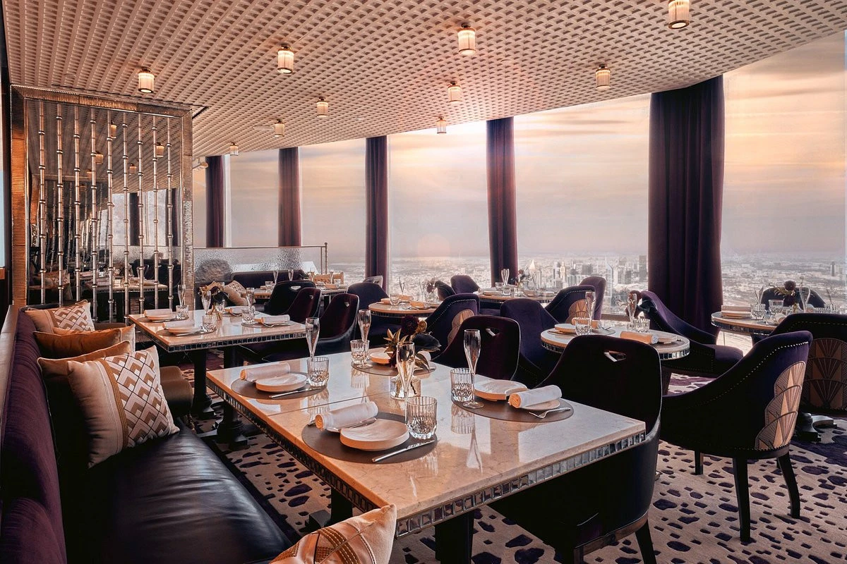 Elegant dining area at Atmosphere Burj Khalifa, overlooking Dubai skyline.