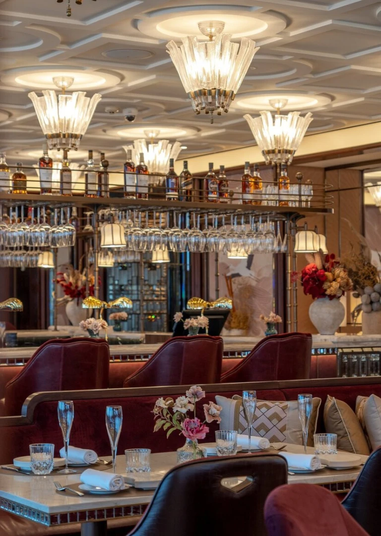 Elegant dining area at Atmosphere Burj Khalifa, Dubai with chandeliers.