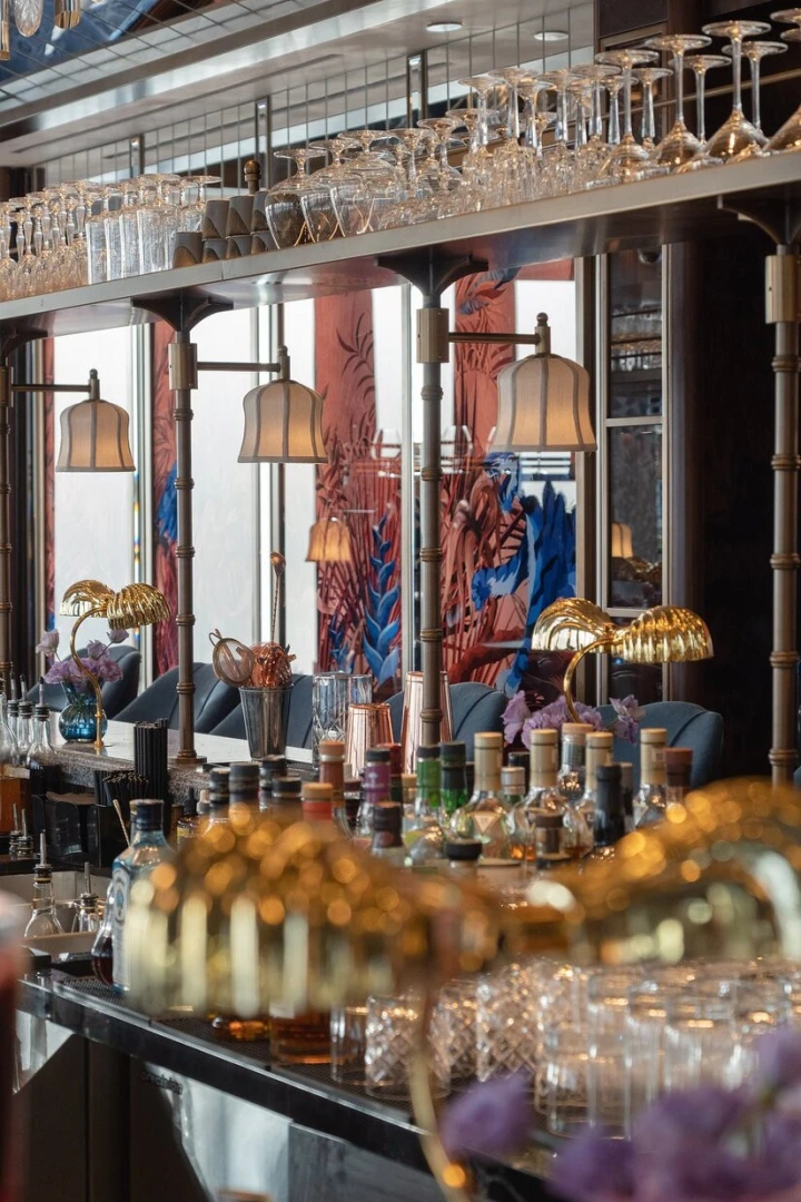 Elegant bar interior at Atmosphere Burj Khalifa, Dubai with glassware display.