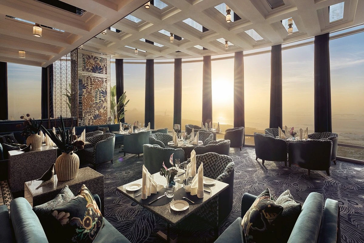 Sunlit dining area at Atmosphere Burj Khalifa with cityscape view.