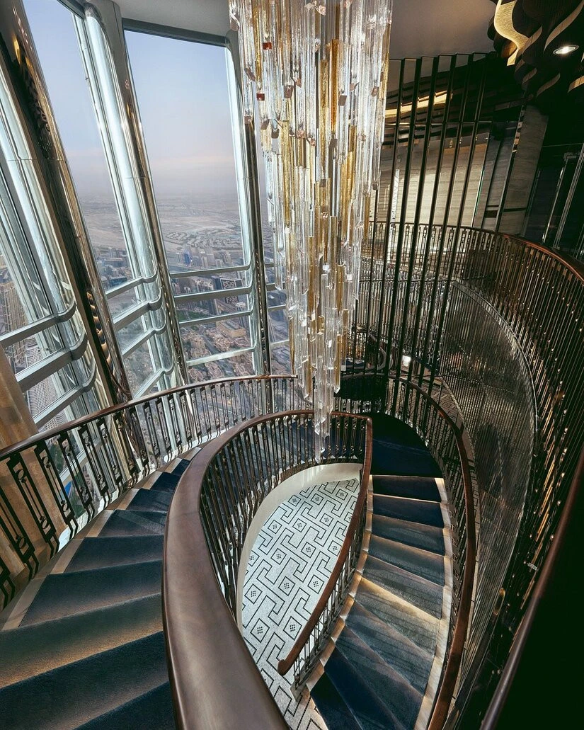 Spiral staircase with chandelier at Atmosphere Burj Khalifa, Dubai.