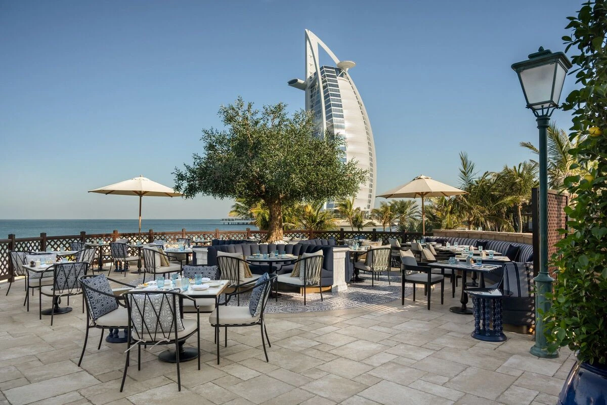 Cala Vista Dubai outdoor dining with sea view and iconic building.