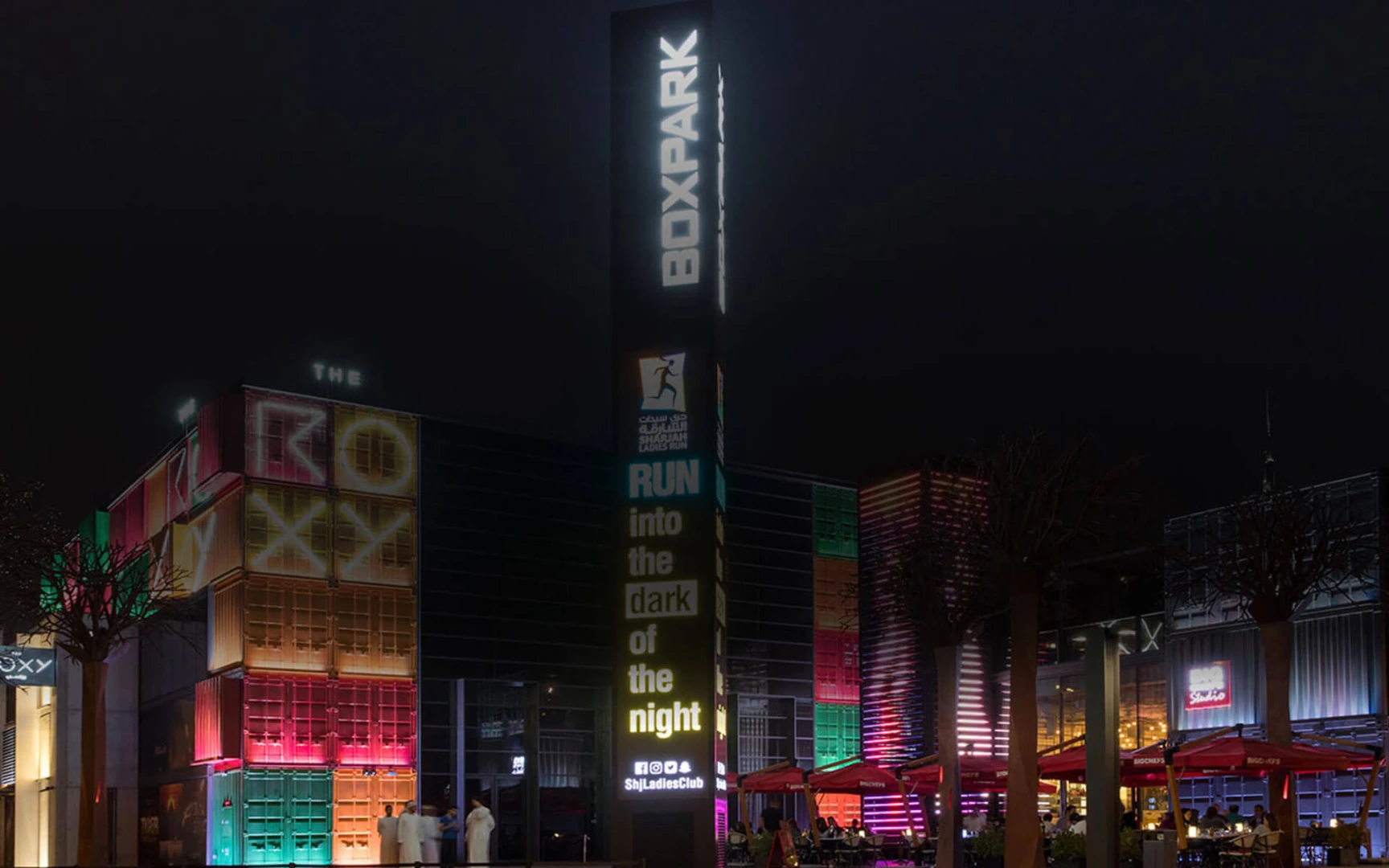 Roxy Cinema Dubai Hills illuminated at night with colorful lights.