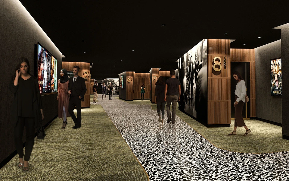 Roxy Cinema Dubai Hills hallway with movie posters and visitors.