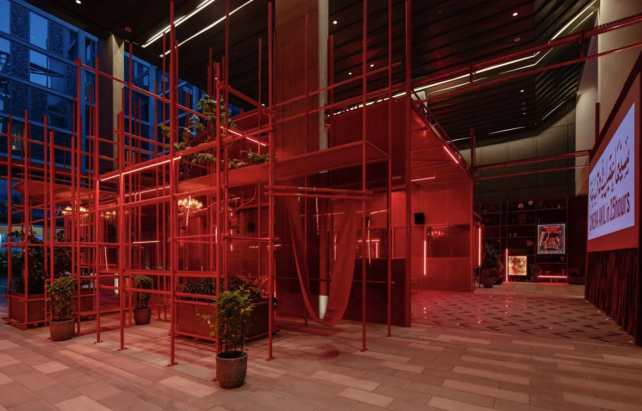 Cinema Akil interior with red lighting, Dubai venue.