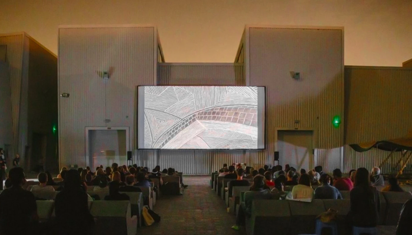 Outdoor screening at Cinema Akil, Dubai, with audience seated.