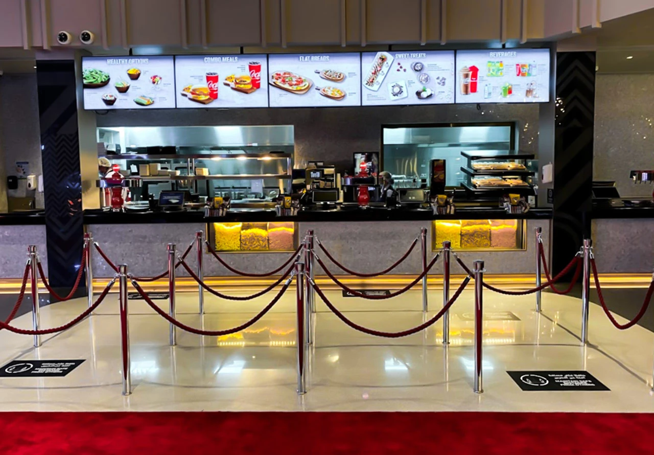 Roxy Cinema Al Khawaneej concession stand with menu screens, Dubai.