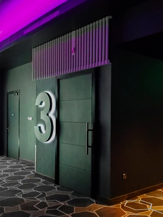 Roxy Cinema Al Khawaneej hallway with door number three, Dubai.