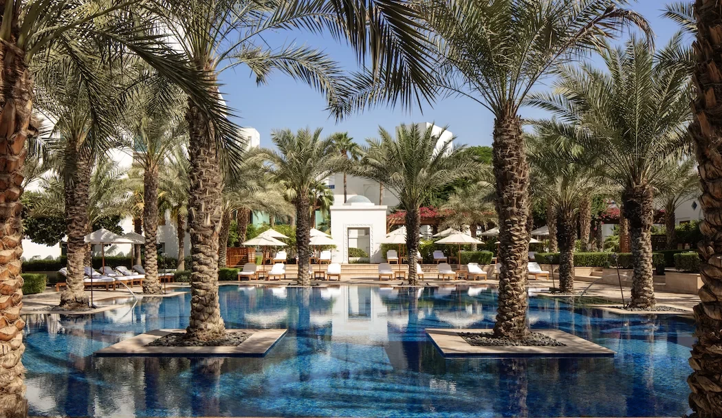 Palm trees surrounding pool at Dubai Creek Golf & Yacht Club.