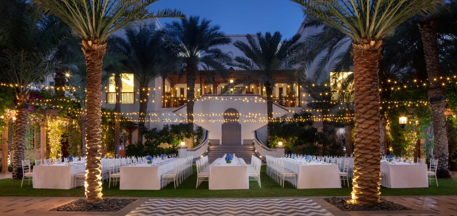 Elegant outdoor dining setup at Dubai Creek Golf & Yacht Club.