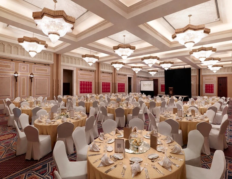 Elegant ballroom setup at Madinat Jumeirah, Dubai, with round tables.
