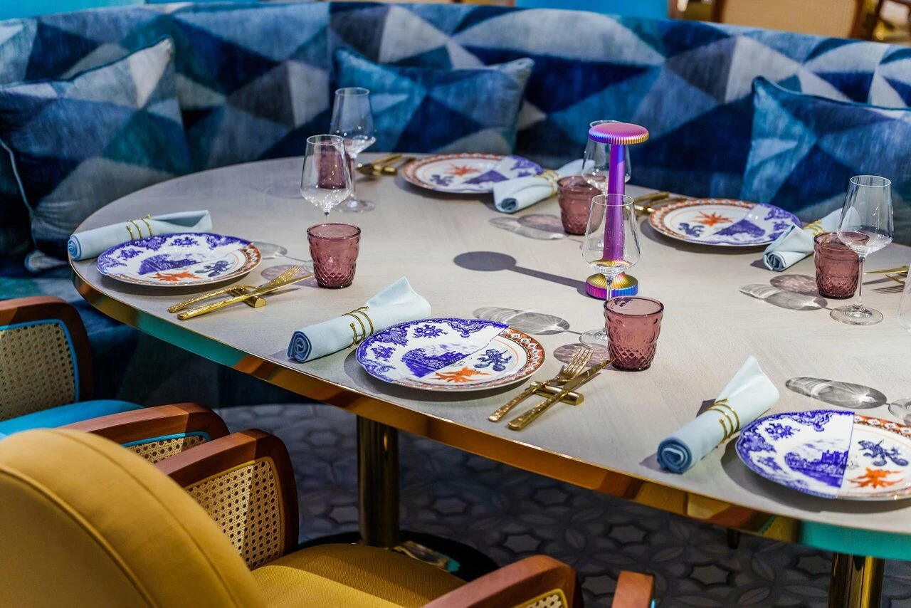 Elegant dining setup at Gallery 7/40 Dubai with patterned plates.