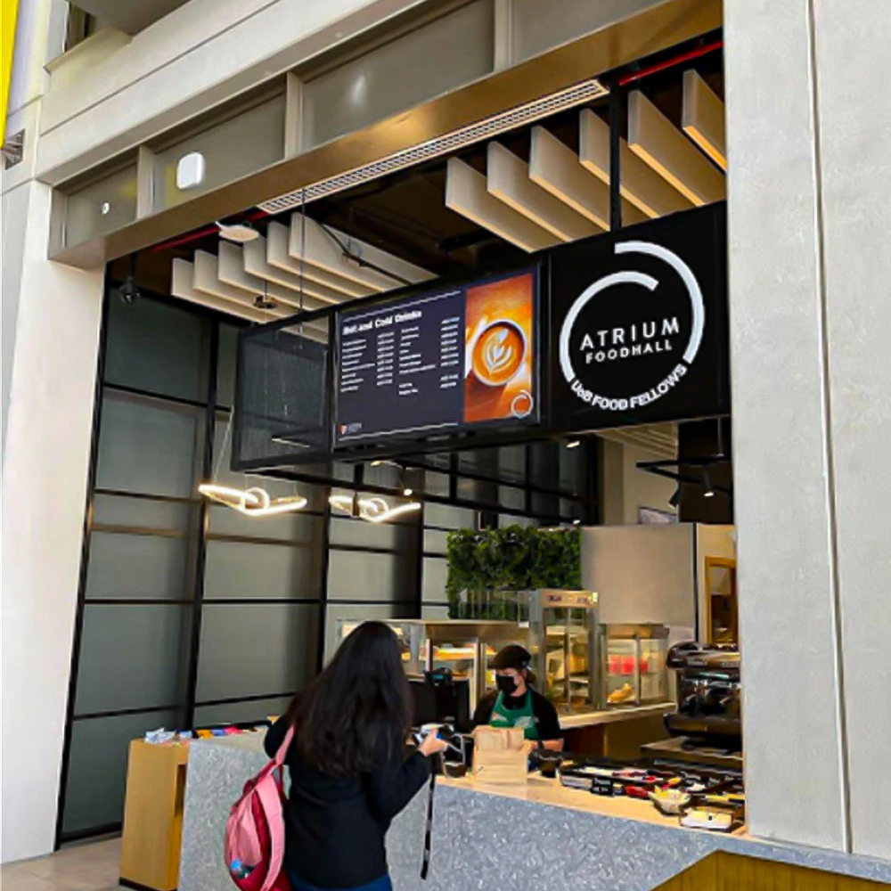 Atrium Foodhall at University of Birmingham Dubai, counter with staff.