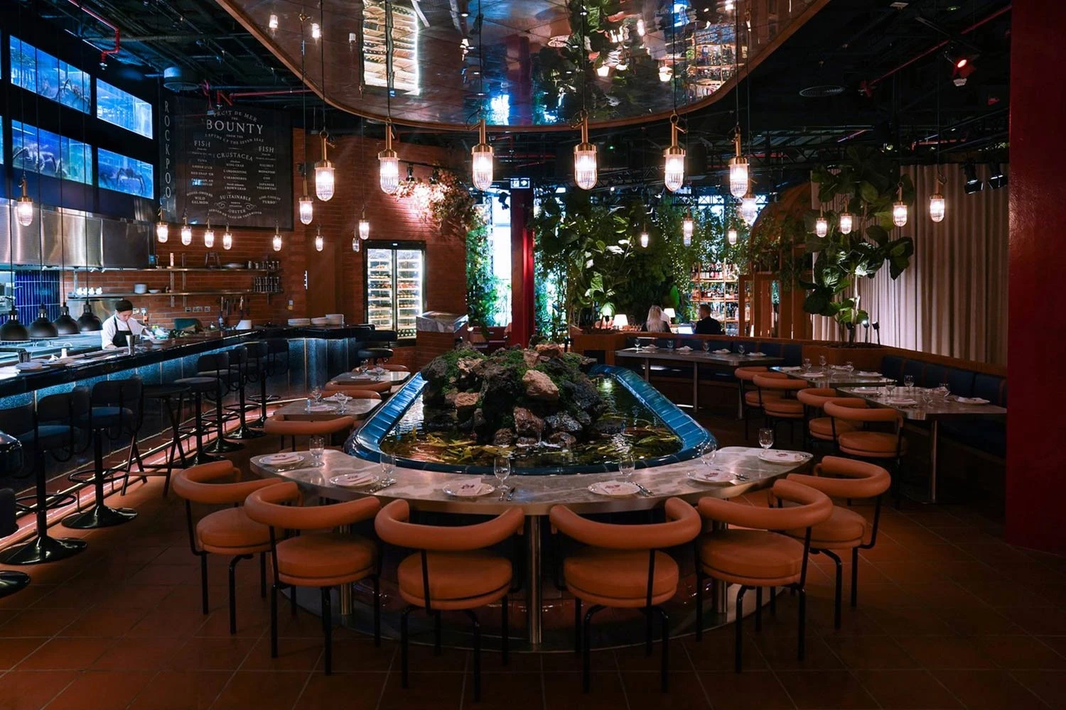 Elegant dining area at The Guild Dubai with central water feature.