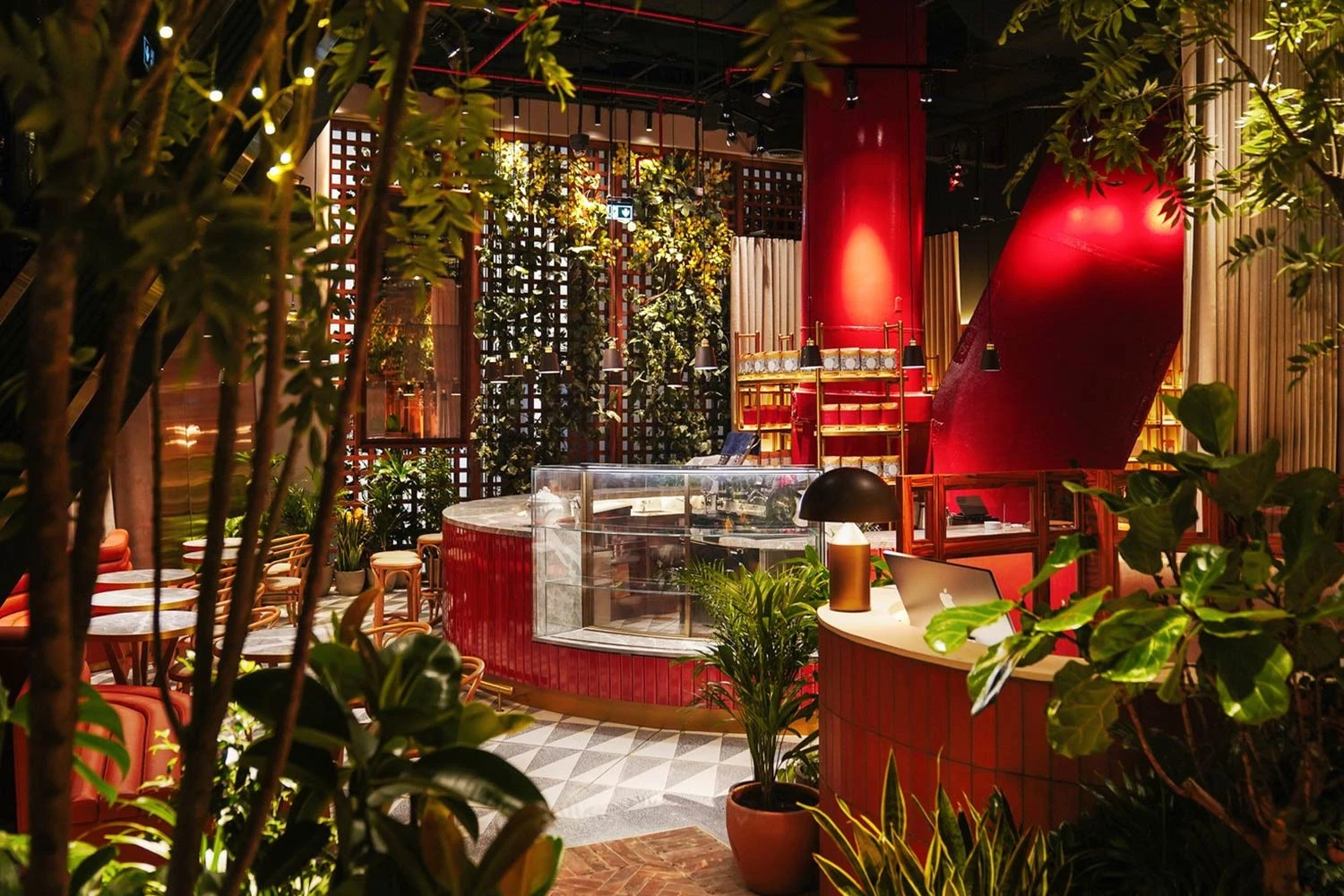 The Guild Dubai interior with vibrant decor and lush plants.