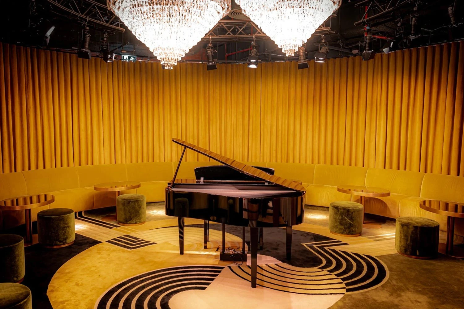Elegant piano room with chandeliers at The Guild Dubai.