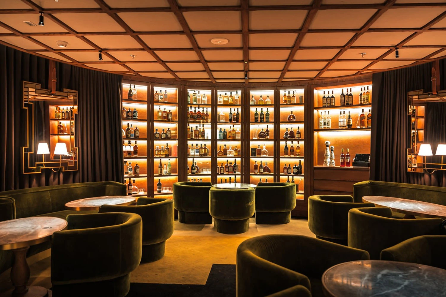 Luxurious lounge with velvet seating at The Guild Dubai.