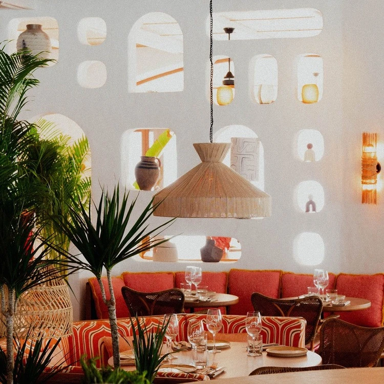 Cozy dining area at Tagomago Dubai with decorative wall niches.