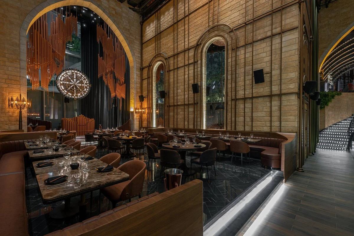 Sophisticated dining setup with arch windows at Amelia, Dubai.