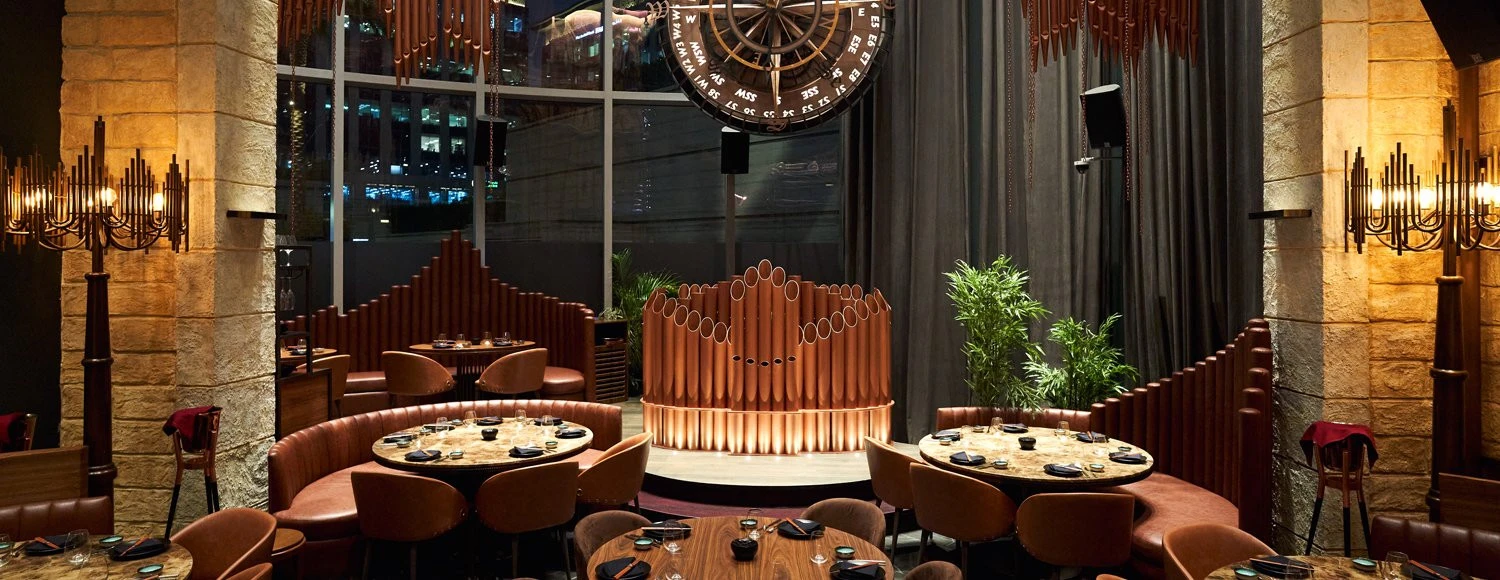 Cozy dining setup with circular tables at Amelia, Dubai.